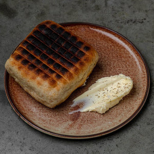 Grilled focaccia over wood fire with whipped butter, whipped ricotta with Anicet honey